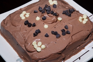 Chocolate cake with chocolate whipped cream icing and chocolate chips