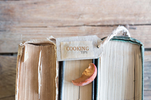 three old books that are designated cooking tips