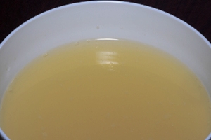 a white soup bowl containing Chinese chicken broth