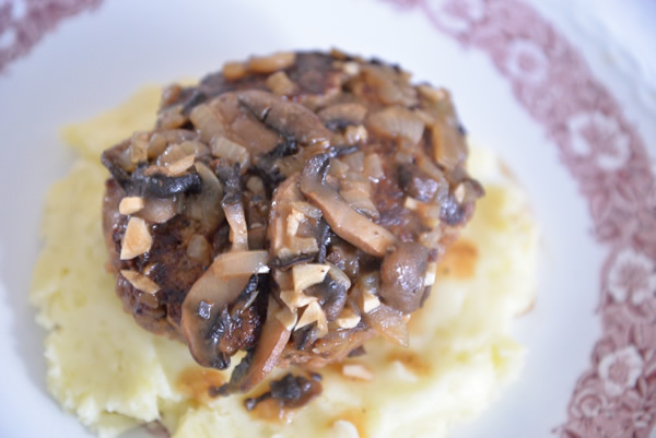 Victorian plate containing Salisbury Steak on mashed potatoes